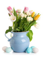 Jug with beautiful flowers and Easter eggs on white background