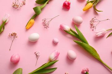 Composition with beautiful flowers and Easter eggs on pink background