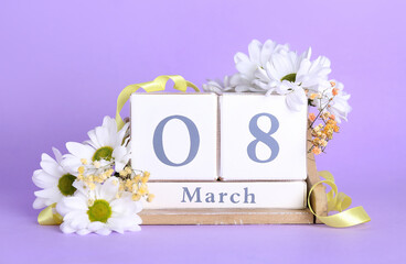 Cube calendar with date MARCH 8 and beautiful chamomile flowers on lilac background. Women's Day celebration