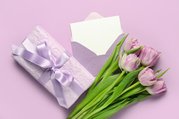 Envelope with blank card, gift and tulips on lilac background. Hello spring