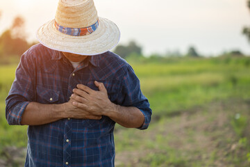 injuries or Illnesses, that can happen to farmers while working. Man is using his hand to cover...
