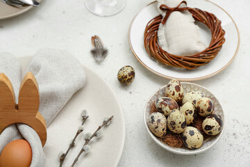 Table setting with Easter eggs and pussy willow branches on white background