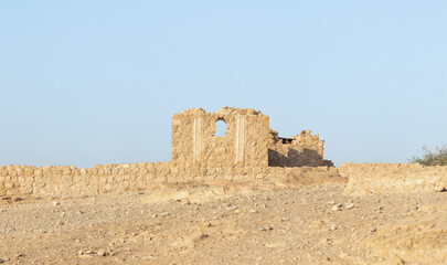 The remains  of internal buildings in the rays of the rising sun in the ruins of the fortress of Masada - is a fortress built by Herod the Great on a cliff-top off the coast of the Dead Sea, Israel