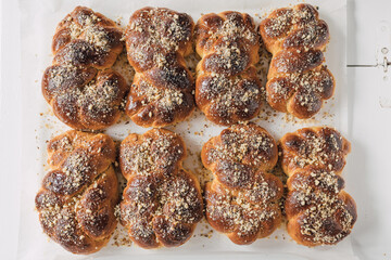 Freshly baked Mucenici: a traditional food in Romania and Moldova. Sweet snack with the shape of number 8, baked from Cozonac dough, glazed with honey and splinkled with walnuts. Christian custom.