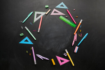 Frame made of different stationery on dark blackboard. Pi Day celebration