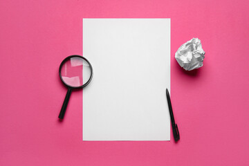 Blank sheet, crumpled paper ball, pen and magnifier on pink background. World Poetry Day celebration