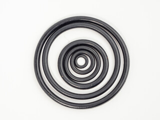 Hydraulic and pneumatic o-rings in black in different sizes on a white background. Rubber gaskets...