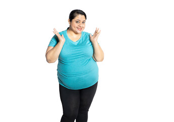 Portrait of happy overweight indian woman standing isolated over white background, Plus size female...