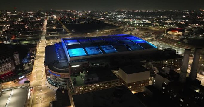Ford Field, home of the Detroit Lions in Detroit, Michigan at night with drone video flying over.