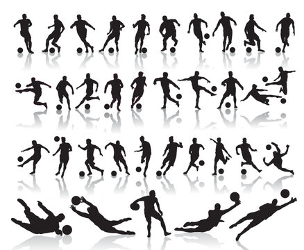 silhouettes of soccer players with the ball