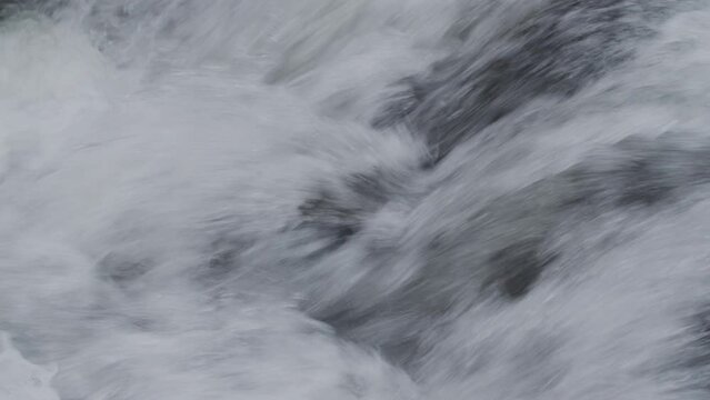 The rapid splashing water stream of a river