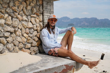 portrait of a man on the beach in krabi thailand with sunglasses