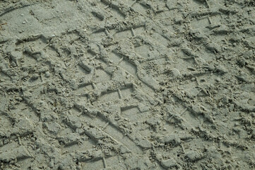 Tire or tyre tracks on sand beach background.
