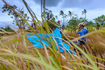 Couple setting up tent, Nusa Penida, Bali, Indonesia