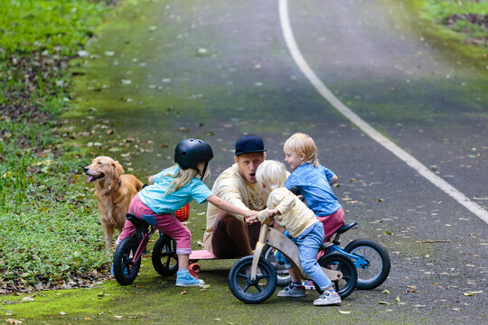 Father with three children in park