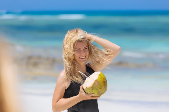 Woman with coconut at beach