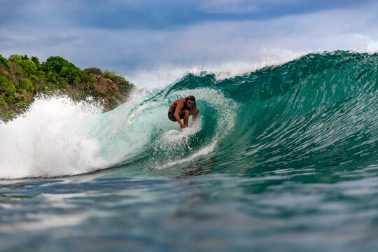 Surfer on wave, Sumbawa, Indonesia