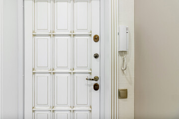 Close up of stylish and elegant door knob or handle on white door. Vintage white and bronze door...