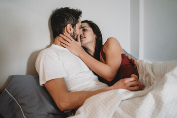 Young romantic couple in bed
