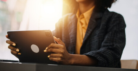 Entrepreneur Asian businessman and businesswoman discussing new business project in tablet in modern Meeting In Modern Office, Asian business casual concept.