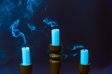 Religious concept.Three blown out candle on Beautiful dark background.candle smoke rises to the...