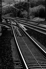 Railway track on main line between Cologne and Frankfurt near Montabaur Germany. High speed railroad with concrete sleepers, steel rails and switches. Black and white greyscale with high contrast.