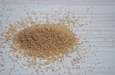 Poppy Seed Isolated on White Wooden Background with Copy Space