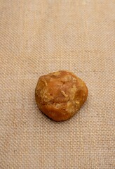 Organic Palm Jaggery or Indian Gur Isolated on Burlap Fabric
