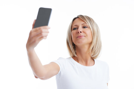 Picture of blonde woman over back isolated background with mobile phone