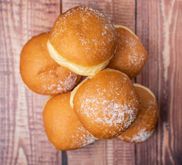 Austrian and german donuts or krapfen. Berliner with cream. Faschingskrapfen. On wooden background. Selective focus., top view, baker concept.