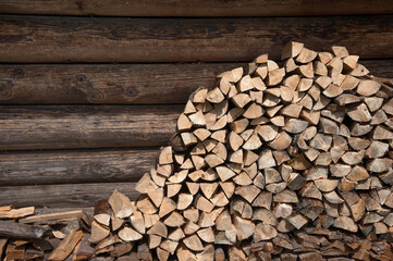 Pile of stacked firewood, prepared for heating the house. Firewood for the winter.   Ecological concept.