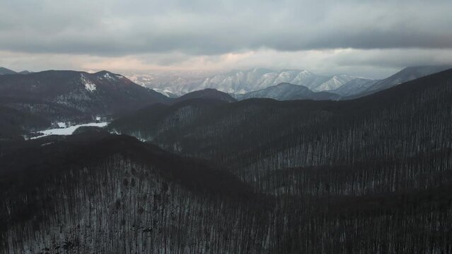 Aerial view of Mount Terminio landscape with snow in wintertime at sunset, Serino, Avellino, Irpinia, Campania, Italy.