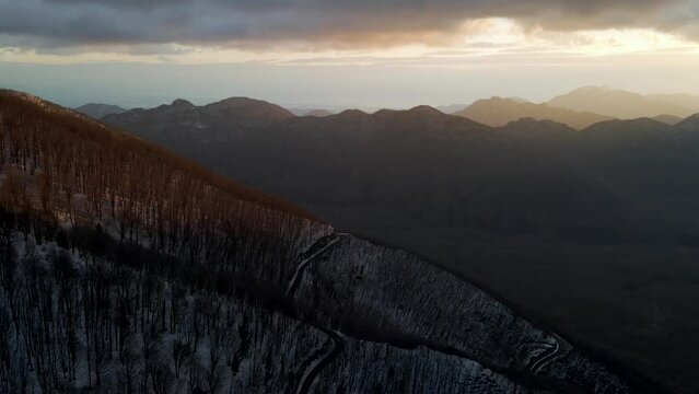 Aerial view of Mount Terminio landscape with snow in wintertime at sunset, Serino, Avellino, Irpinia, Campania, Italy.