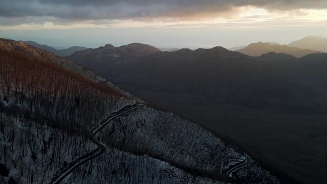 Aerial view of Mount Terminio landscape with snow in wintertime at sunset, Serino, Avellino, Irpinia, Campania, Italy.