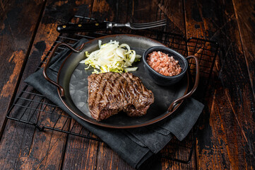 Deer venison steak with   sea salt and salad. Wooden background. Top view - obrazy, fototapety, plakaty