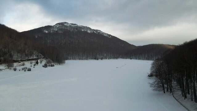 Aerial view of Verteglia Plateau with snow in wintertime at sunset on Mount Terminio, Serino, Avellino, Irpinia, Campania, Italy.
