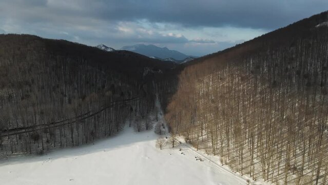 Aerial view of Verteglia Plateau with snow in wintertime at sunset on Mount Terminio, Serino, Avellino, Irpinia, Campania, Italy.