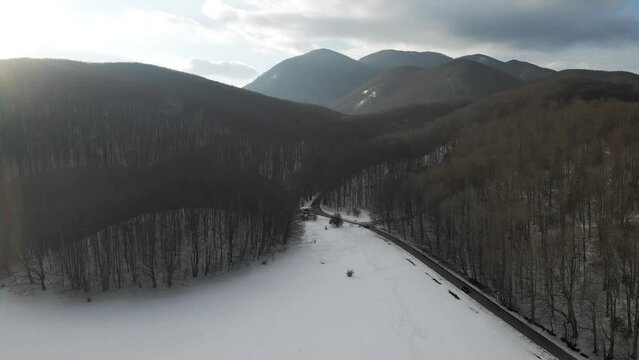 Aerial view of Verteglia Plateau with snow in wintertime at sunset on Mount Terminio, Serino, Avellino, Irpinia, Campania, Italy.
