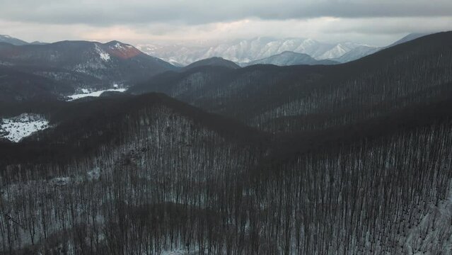 Aerial view of Mount Terminio landscape with snow in wintertime at sunset, Serino, Avellino, Irpinia, Campania, Italy.