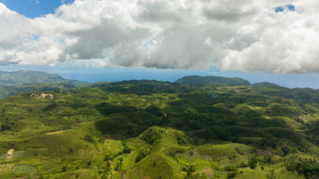 Aerial view of agricultural land among hills and mountains in a mountainous province. Libo hills. Cebu island, Philippines.