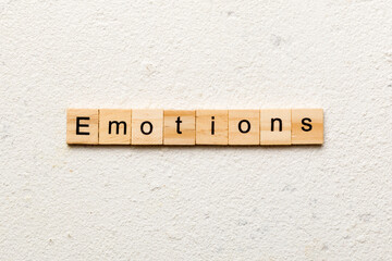 EMOTIONS word written on wood block. EMOTIONS text on cement table for your desing, concept