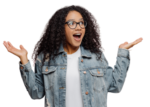 Photo of pleased surprised African American woman raises palms, keeps jaw dropped from wonder, focused away, wears transparent glasses and denim jacket, isolated on pink background. Reaction concept