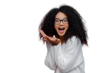 Overjoyed happy curly young woman with cheerful expression, keeps mouth widely opened, wears casual white jumper and optical glasses, poses over violet background. Emotions and happiness concept