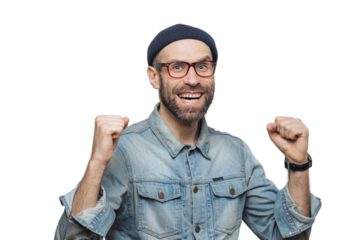 Portrait of happy successful man rejoices his triumph, clenches teeth, has overjoyed expression, isolated over grey background. Handsome fashionable male celebrates his victory. Achievement concept