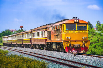 Obraz premium Passenger train by diesel locomotive on the railway.
