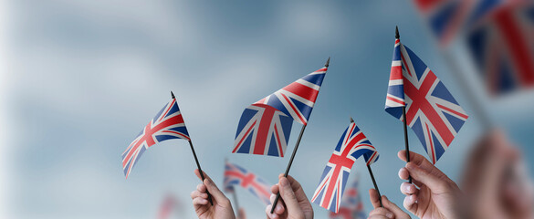 A group of people holding small flags of the United Kingdom in their hands