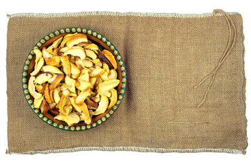 Wheat in a clay plate stands on a rural bag. Vegetarian organic foods.Top view.