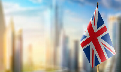 Small flags of the United Kingdom on an abstract blurry background - obrazy, fototapety, plakaty