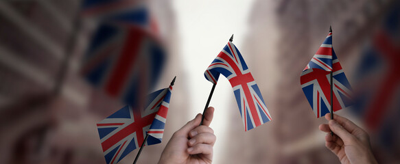 A group of people holding small flags of the United Kingdom in their hands