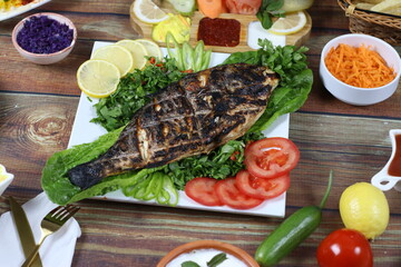 BBQ Grilled Fish Dish Served with Parsley, Lettuce and Slices of Lemon and Tomato -  Seafood Dinners
